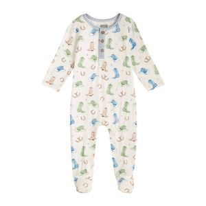 A baby footed sleeper in a cream color with a colorful dinosaur print, featuring a three-button placket at the neck.