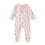 A baby long-sleeve footed romper in cream with a colorful pattern of pink flamingos, blue birds, and brown boots, featuring a pink collar and snap button henley neckline.