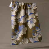 Floral patterned fabric hanging on a line against a plain background