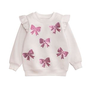 White sweater with pink bows on a white background