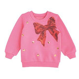 Pink sweatshirt with a large orange bow and gold buttons on a white background