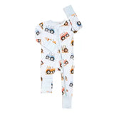 A baby long-sleeve footless zip-up sleeper in white, featuring an all-over print of colorful cartoon construction vehicles including tractors, dump trucks, and cranes.