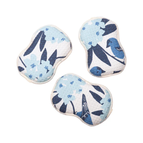 Three heart-shaped pillows with blue floral pattern on a white background