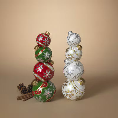 Decorative Christmas ornaments stacked on a beige background