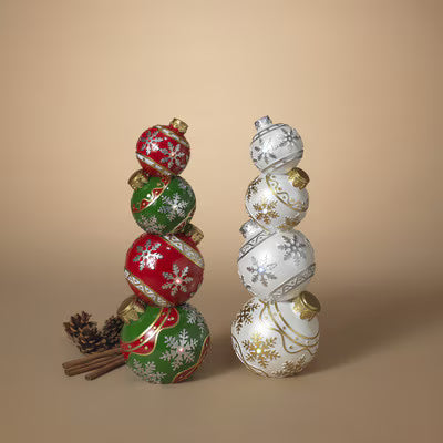 Two decorative tall ornaments stacked with Christmas-themed designs on a beige background