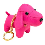 Pink dog-shaped keychain with a gold ring on a white background
