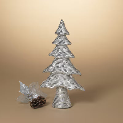 Decorative silver Christmas tree with a pine cone and leaf on a beige background