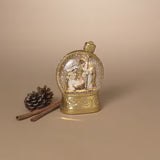 Decorative snow globe with a gold base on a beige background