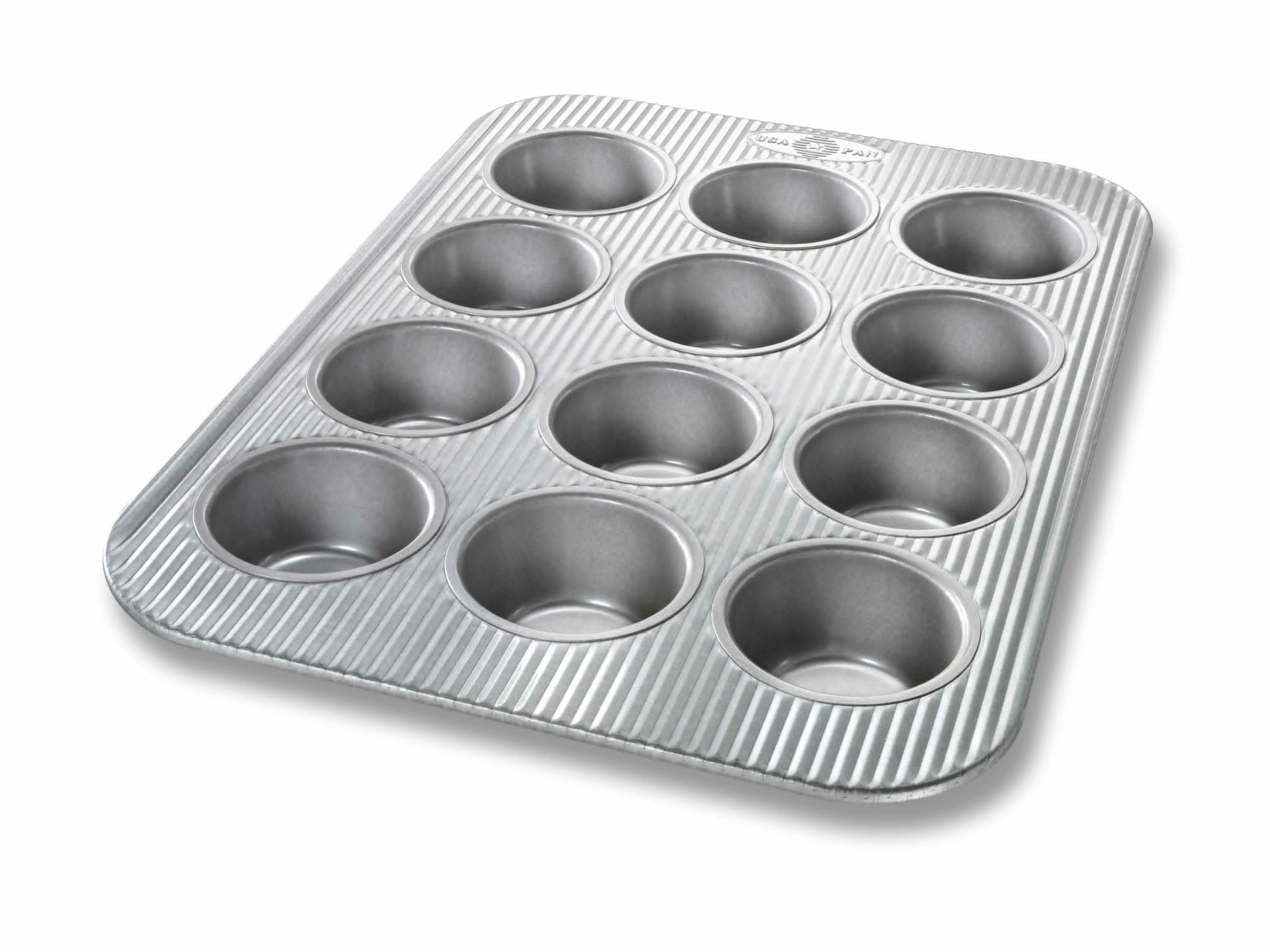 Metal muffin tin with multiple compartments on a white background