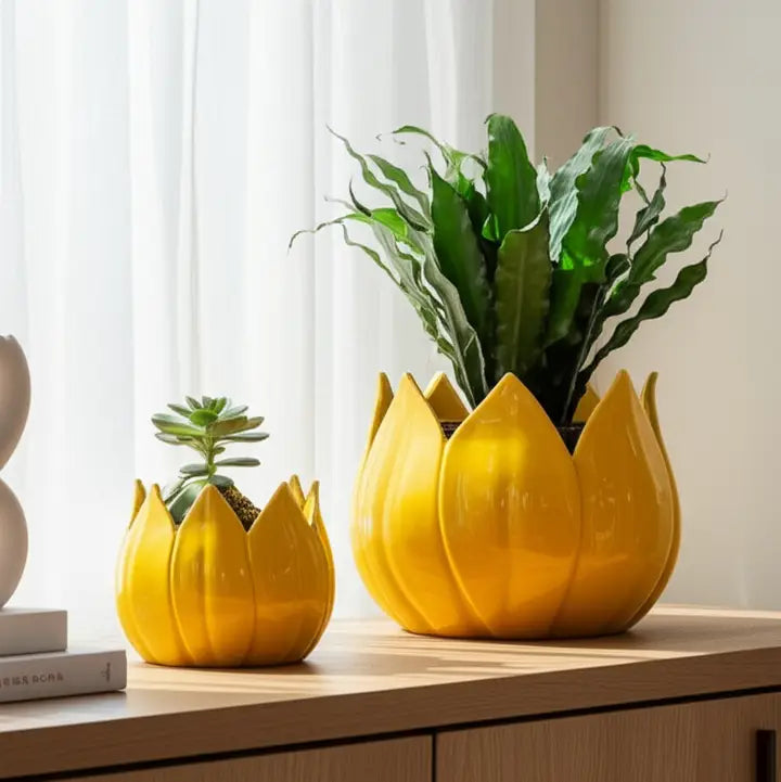 Yellow lotus-shaped planters with green plants on a wooden surface.