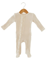 Beige baby onesie with ruffles on a wooden hanger against a white background