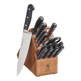 Set of knives in a wooden block on a white background
