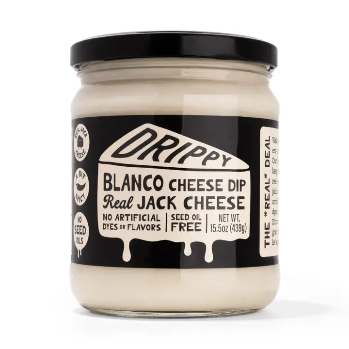 Jar of Drippy Blanco Cheese Dip with black lid on a white background