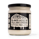 Jar of Drippy Blanco Cheese Dip with black lid on a white background