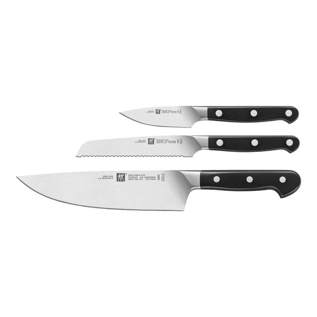 Set of four knives with black handles on a white background