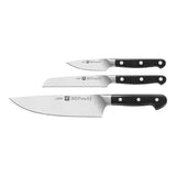 Set of four knives with black handles on a white background
