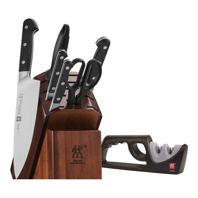 Knife set with wooden block and sharpener on a white background