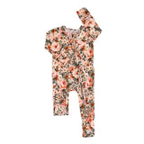 A baby footed one-piece sleeper with a floral print, featuring a front zipper and a matching flat bandana cap, displayed on a solid white background.