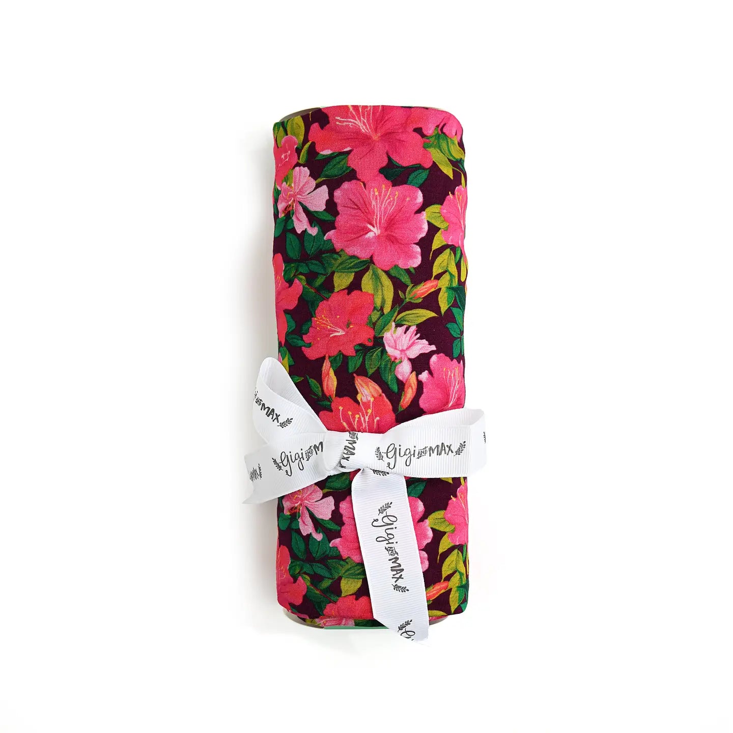 A rolled-up bamboo swaddle blanket with a floral pattern, tied with a ribbon.