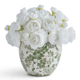 White faux rose artificial flower bouquet in a green and white patterned ceramic vase, photographed on a clean white background.