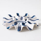 White ceramic dish with blue wave patterns on a white background