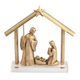 A gold-finished nativity scene figurine featuring Mary, Joseph, and baby Jesus under a star-topped stable roof on a clear acrylic base, shown against a plain white background.