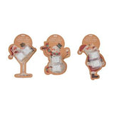 Three Christmas-themed acrylic wall signs shaped like a martini glass, gingerbread man, and Santa Claus, each with a tan backing card, shown on a plain white background.