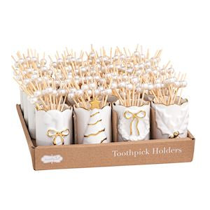 A set of five white toothpick holders in a brown cardboard tray, decorated with gold bows and gold line details, holding multiple wooden toothpicks topped with white faux pearls, on a white background.