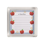 A square clear plastic case containing a lined notepad printed with red apples, small gold stars, and the words 'my teacher' at the top.