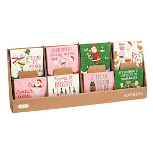 Set of Christmas-themed napkins in a cardboard holder on a white background