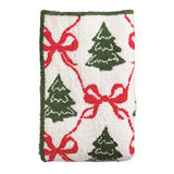 Festive towel with Christmas tree and bow pattern on a white background
