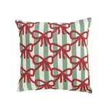 Decorative pillow with red bows on green and white striped background