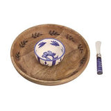 Wooden bowl with decorative leaves, ceramic bowl with blue floral design, and knife with purple handle on a white background