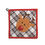 A square fabric pot holder or potholder with a red border, featuring a white plaid pattern with green, blue, and red stripes, and a crocheted reindeer face with brown antlers and a red nose. A small metal loop is attached to the top left corner.