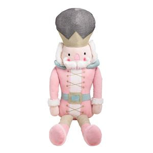 Plush toy resembling a character from a Nutcracker story, dressed in pink and gray outfit.