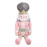 Plush toy resembling a character from a Nutcracker story, dressed in pink and gray outfit.