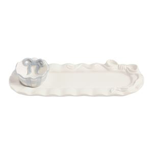 White ceramic tray with wave design on a white background