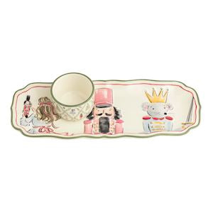 A decorative ceramic tea cup with a matching long rectangular tray featuring illustrated nutcracker and fairy characters, shown on a plain white background.