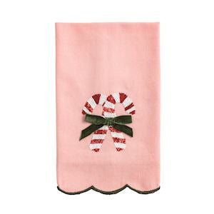 Pink towel with candy cane and bow design on a white background
