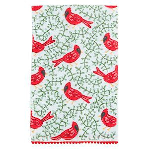 Patterned fabric with red cardinals and green leaves on a white background