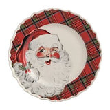 A scalloped ceramic Christmas plate featuring a vintage-style illustration of Santa Claus on the left and a red and green plaid border around the rim.