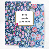 Two fabric panels with house and floral patterns and text 'cool people live here'.