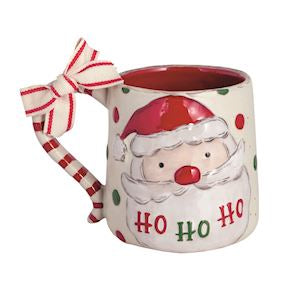 Decorative mug with Santa face and candy cane handle on a white background