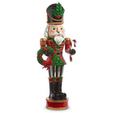 Decorative Christmas nutcracker figurine with a wreath and candy cane on a white background