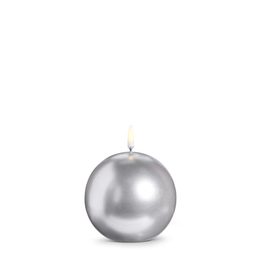 Silver spherical candle on a white background