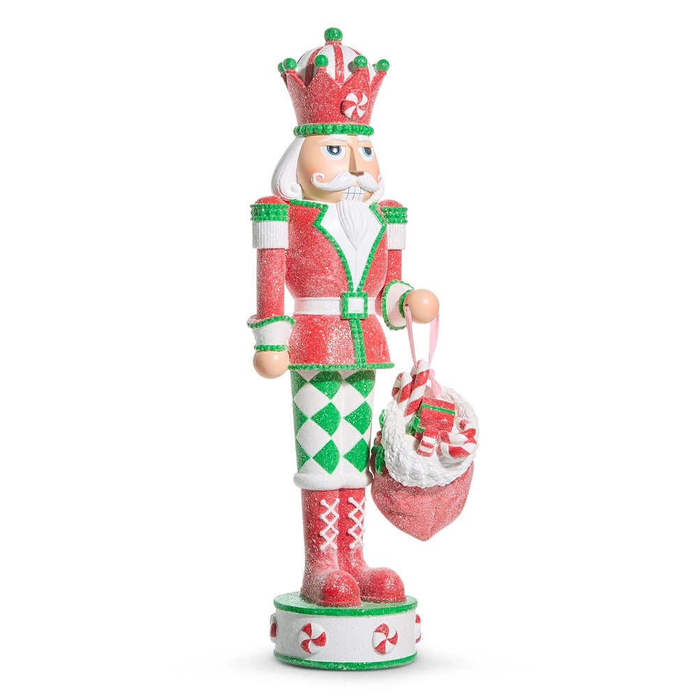 Decorative Christmas nutcracker figurine with red and green outfit on a white background