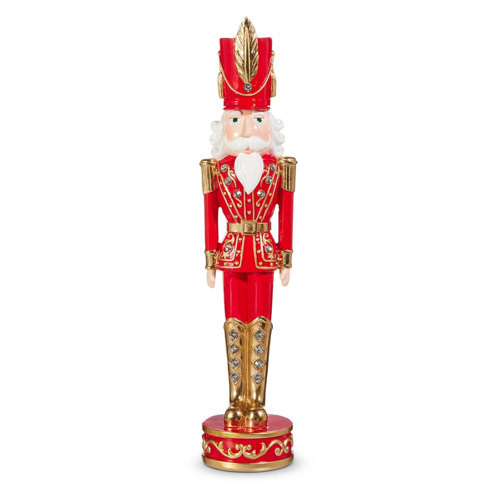 Decorative nutcracker figure in red and gold attire on a white background
