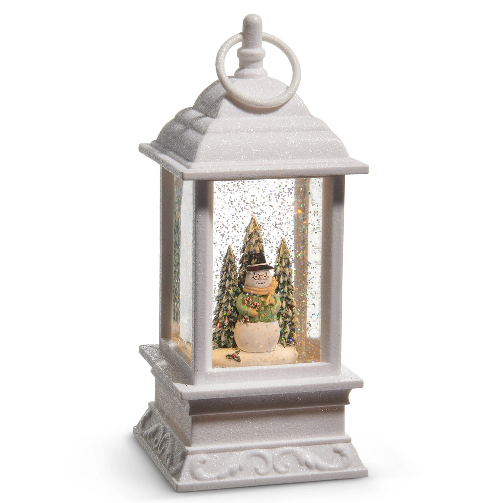 Decorative lantern with a snowman and Christmas trees inside on a white background