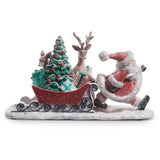 Decorative figure of Santa Claus with a sleigh full of Christmas tree and gifts on a white background