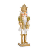 Decorative nutcracker figure in gold and white attire with a crown on a white background